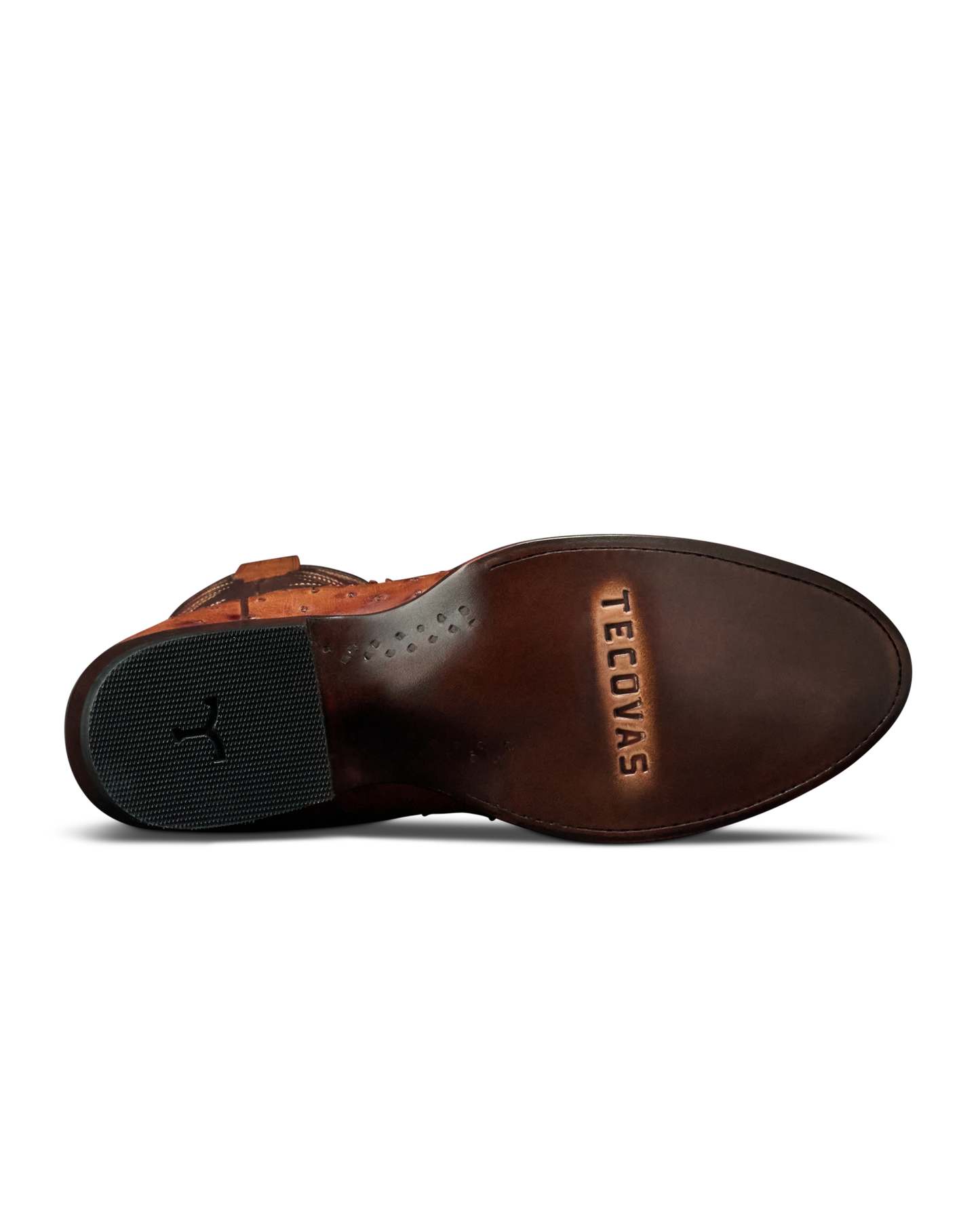 The outsole of a brown leather boot by Teecovas, showing the brand name embossed on the heel area and a black rubber heel block.
