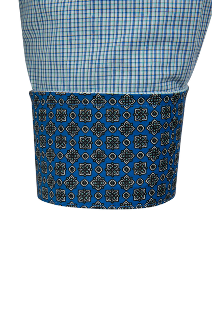 Close-up of a shirt cuff showing a blue and white gingham upper section and a folded cuff with a blue, black, and white geometric pattern.