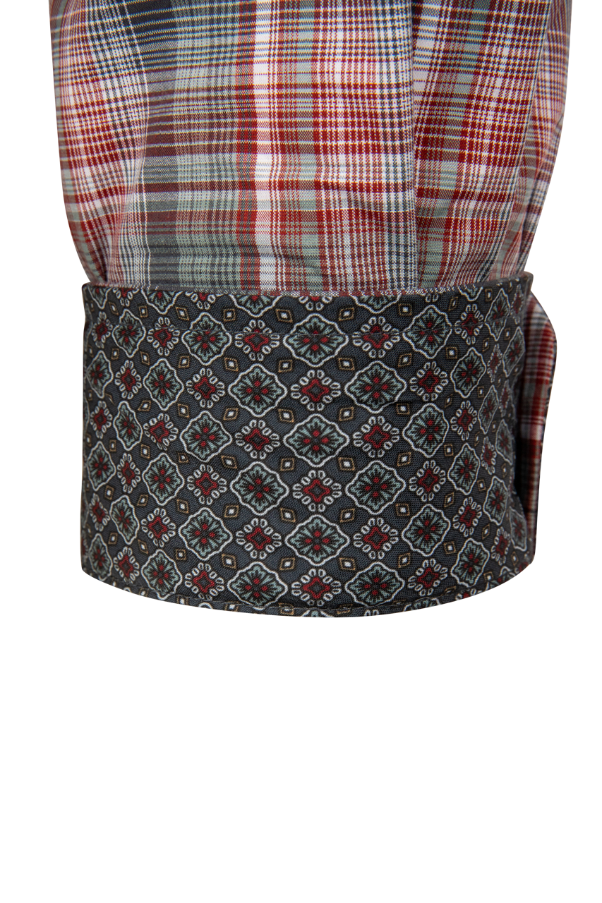 A close-up of a traditional shawl collar garment, featuring a red, white, and gray plaid upper section and a dark gray patterned lower band with a repeating geometric medallion design.