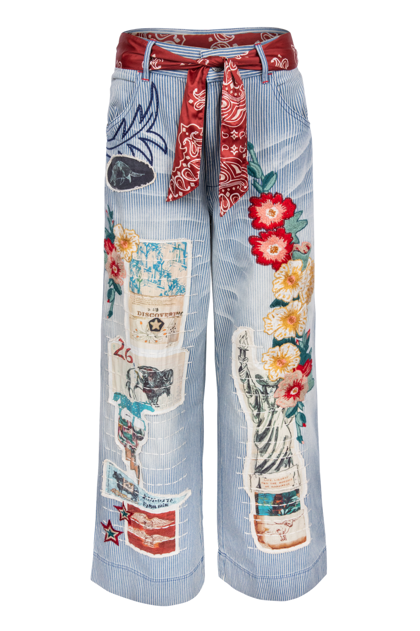 Light blue and white stripe jeans with colorful patches and a red bandana belt