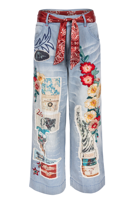 Light blue and white stripe jeans with colorful patches and a red bandana belt