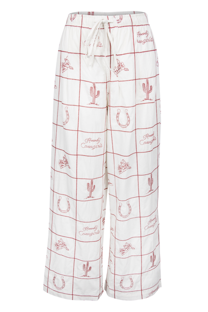 White wide-leg lounge pants with a red grid pattern and western-themed motifs including cacti, horseshoes, and the words 'Family Cowboys'.