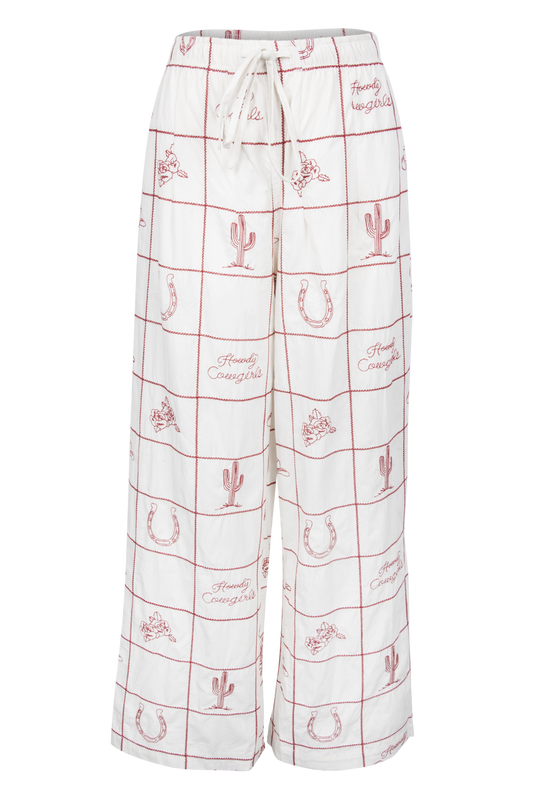 White wide-leg lounge pants with a red grid pattern and western-themed motifs including cacti, horseshoes, and the words 'Family Cowboys'.