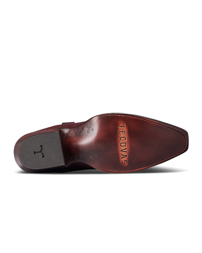 A close-up bottom view of a brown leather shoe showing the outsole, heel, and embossed brand name 'TECOVAS' on a white background.
