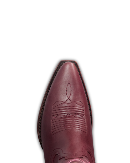 A close-up top-down view of a pointed-toe western boot in burgundy leather, showing decorative stitching on the vamp against a plain white background.