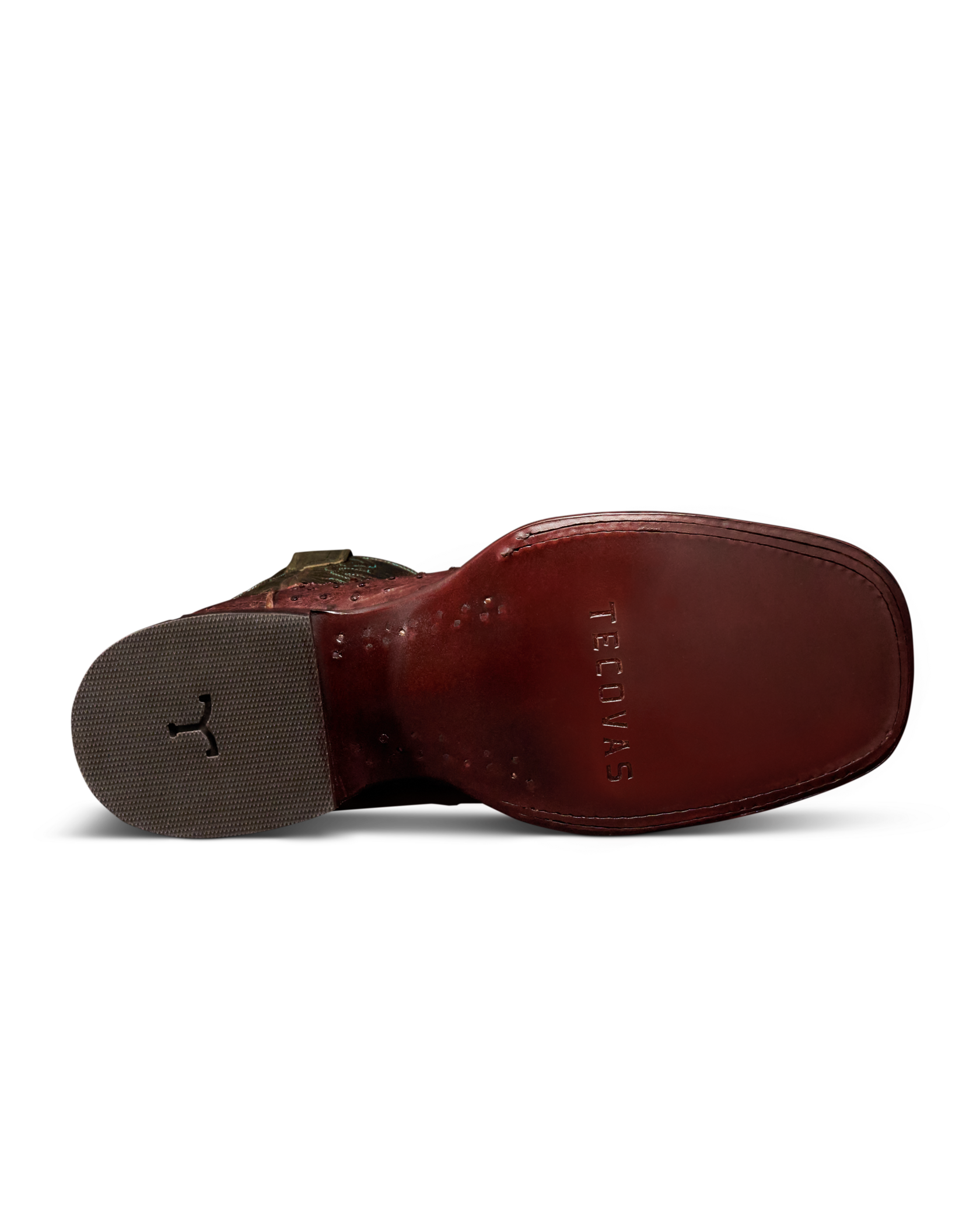 The bottom sole view of a brown leather boot by Tecnovas, showing the embossed brand name on the footbed and a textured gray heel.