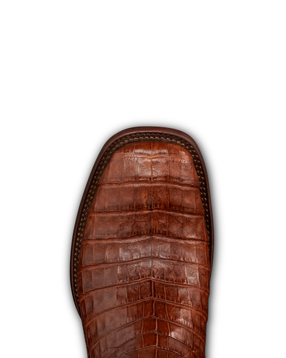 Close-up of a brown crocodile-embossed leather boot toe with a stitched edge